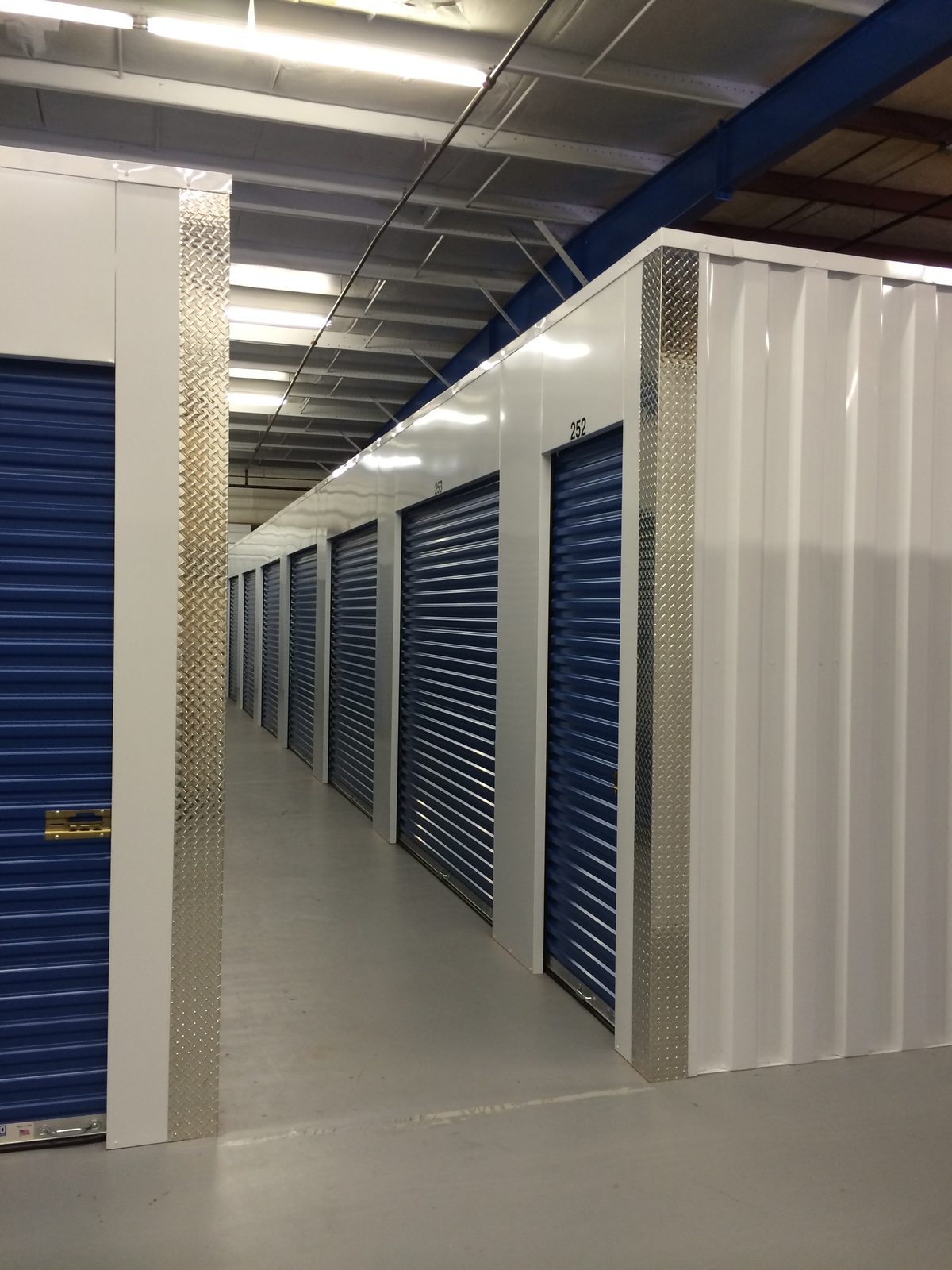 Climate-controlled storage units with blue roll-up doors at Citywide Moving Systems Monroe NC